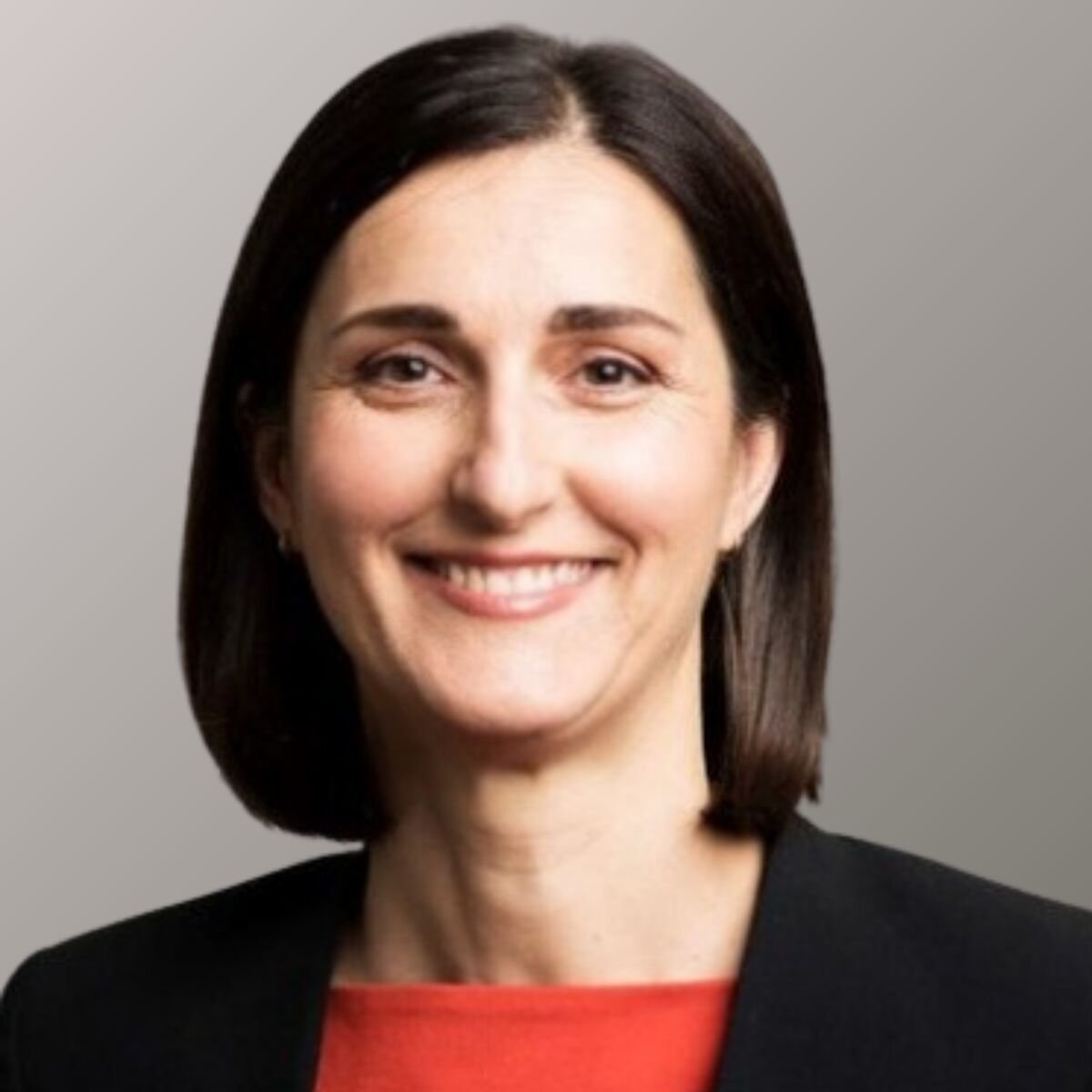 Portrait of Natalia Nikolova. She's wearing black jacket and orange shirt.