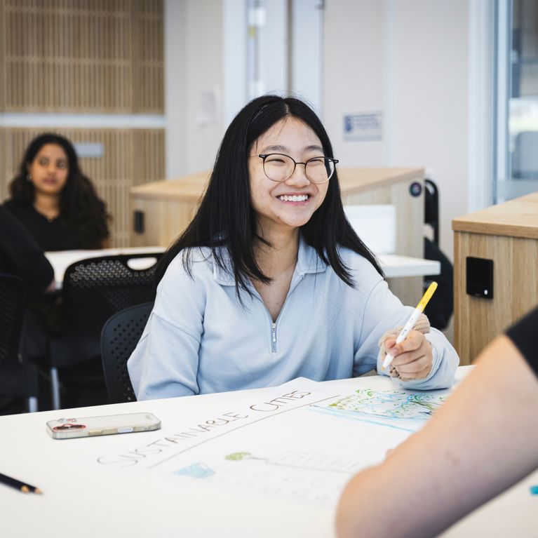 Student smiling in class.