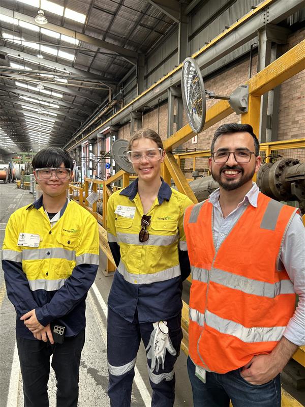 People in hard hat at factory