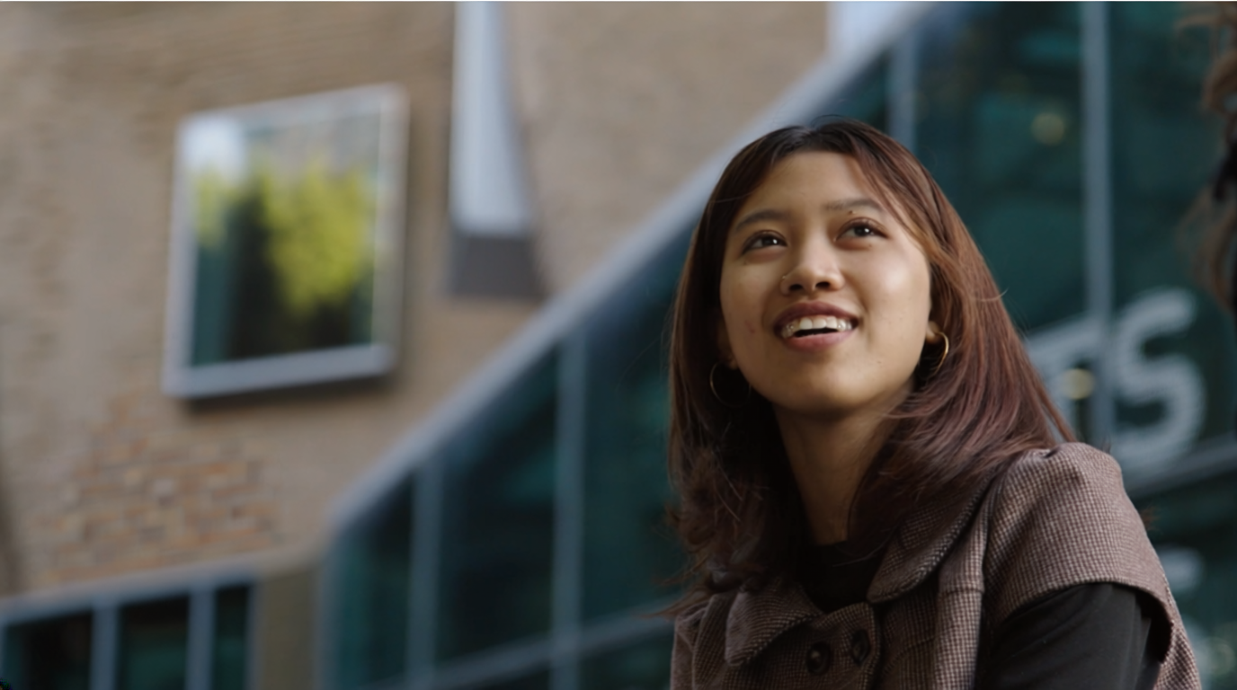 Image of person smiling looking diagonally up