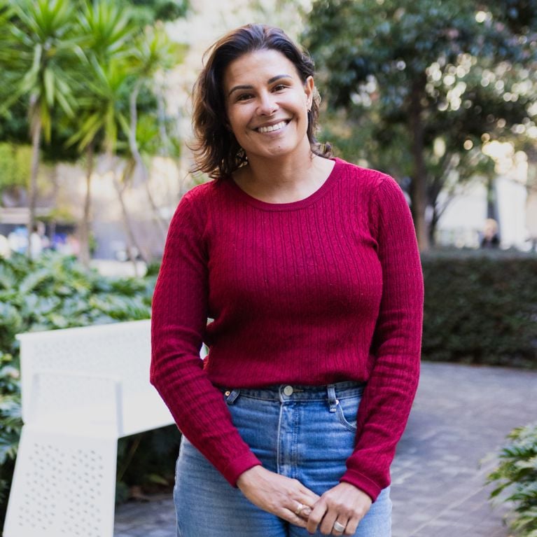 Kristal Kinsela smiling and looking at the camera in a red top
