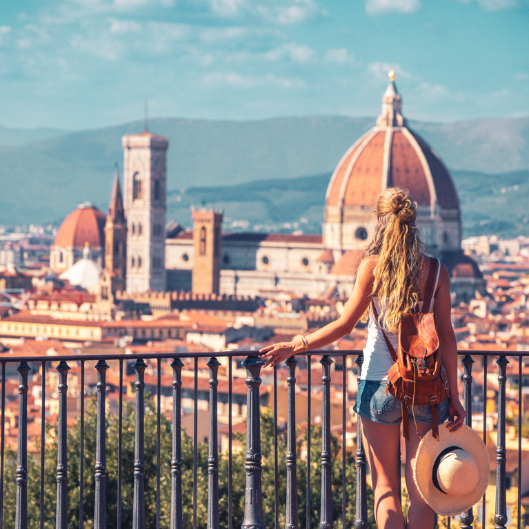 Woman traveling in Italy, enjoying panoramic view of Florence Cityscape