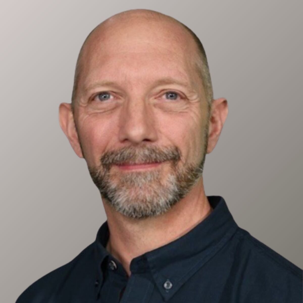 Portrait of Dr Jochen Schweitzer, he's wearing a black dress shirt.