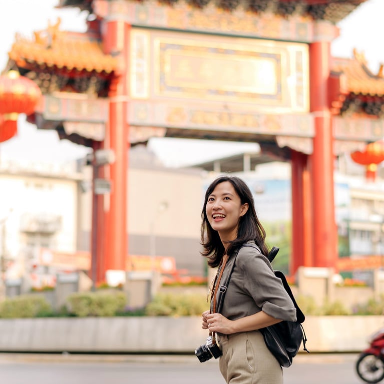 Young Asian woman backpack traveler enjoying China town in Bangkok, Thailand.