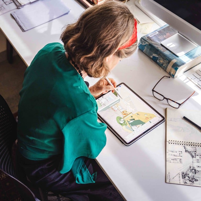 Doctor Samantha Donnelly sketching designs for refuge spaces on a tablet.