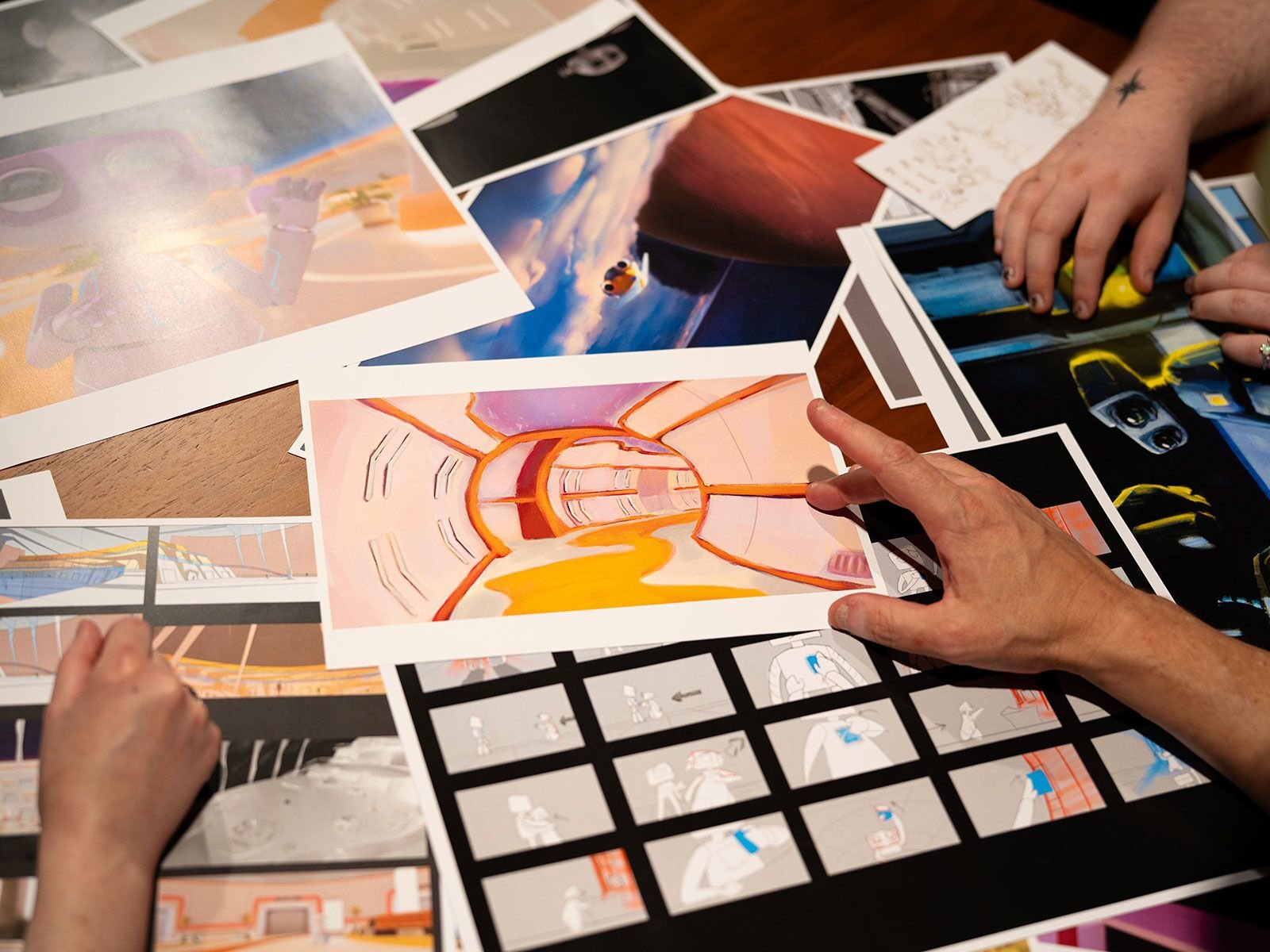 Animation students review concept drawings for the film Alone.