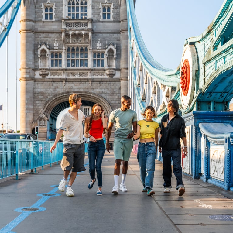 Multiracial group of happy young friends bonding in London city