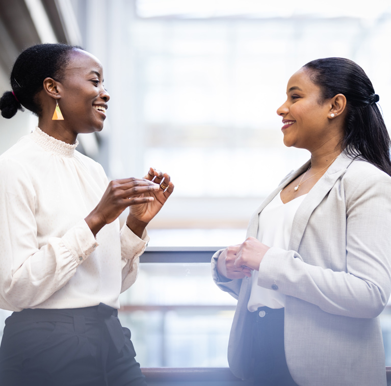 A Doctor of Philosophy student and a professor talking.