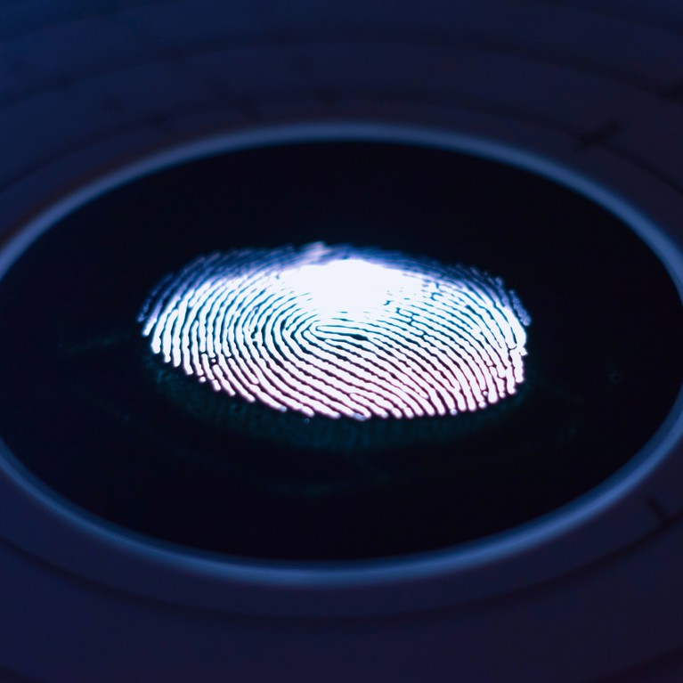 White fingerprint on a black background with a blue circle around it