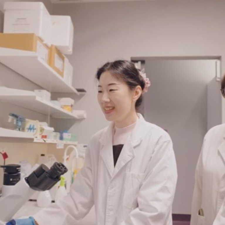 Dr Jiao Jiao Li with two other UTS researchers viewing research data on a desktop computer in a lab