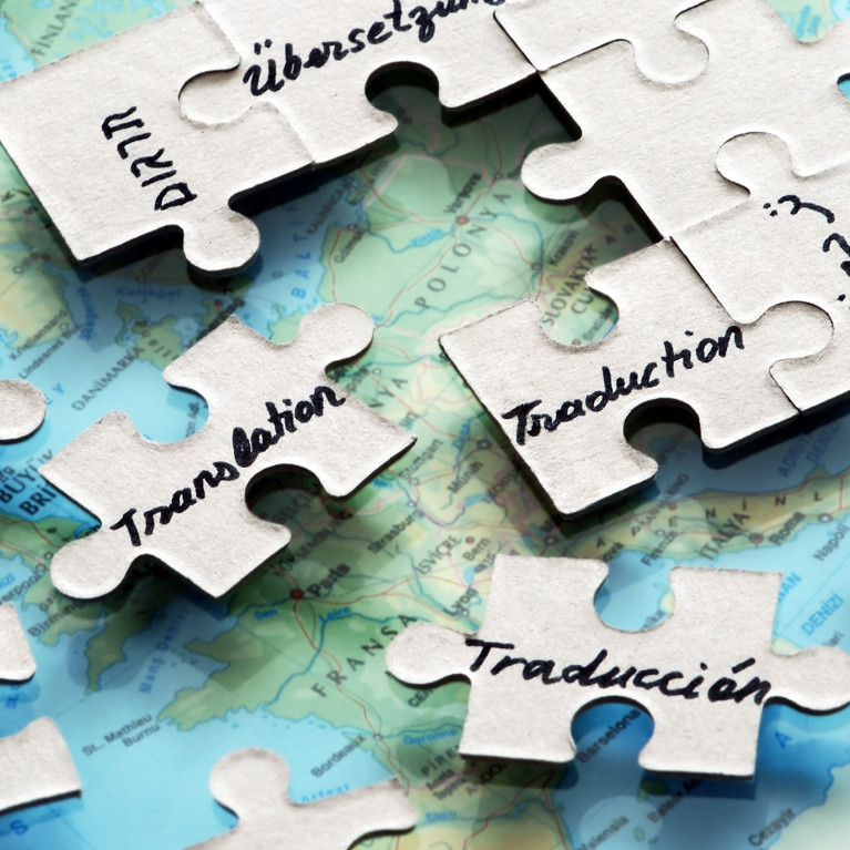 Puzzle pieces on top of a map. The word