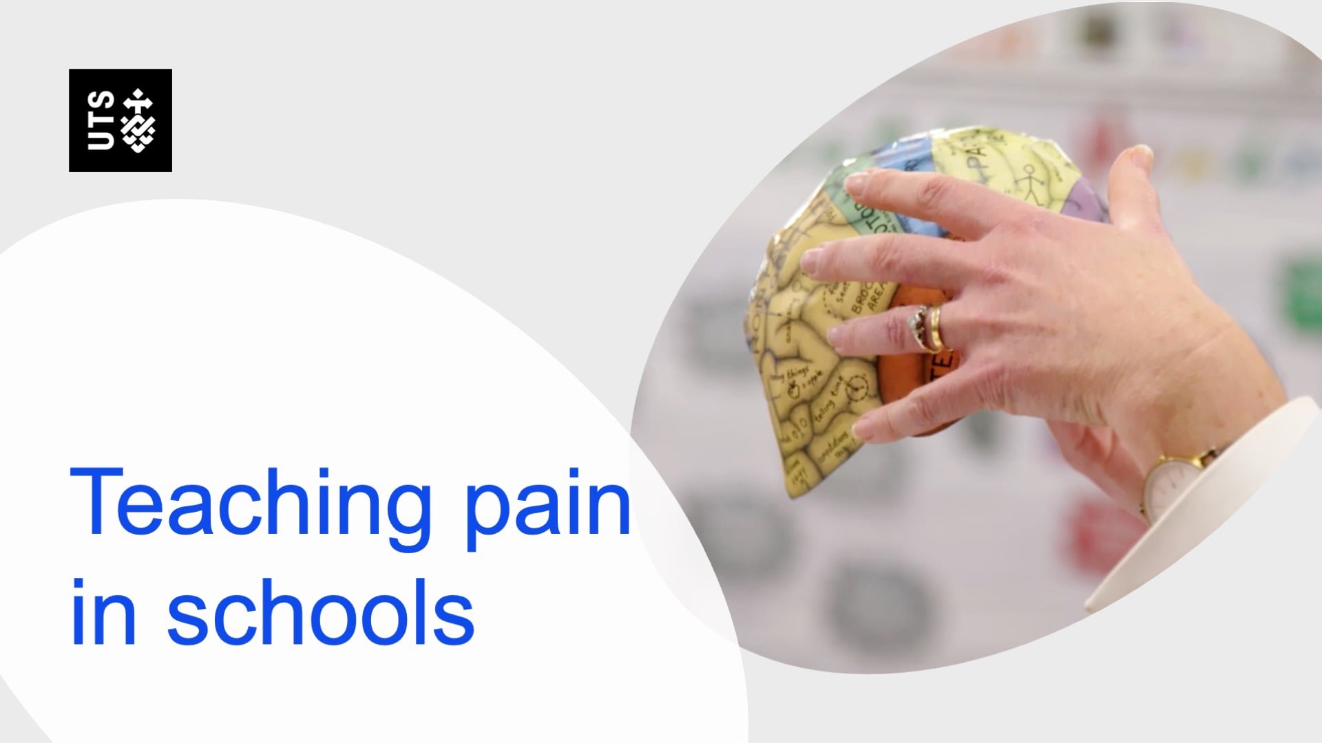 A hand holds a colourful brain model beside text reading "Teaching pain in schools." The tone is educational. UTS logo is in the top left corner.