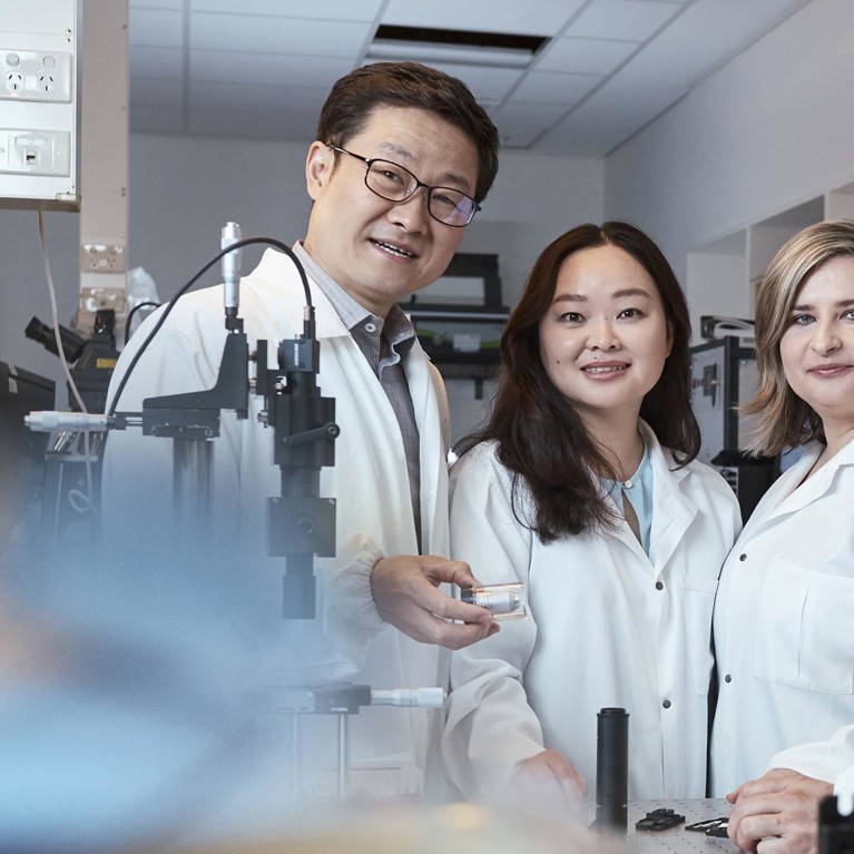 Four UTS scientists in lab posing for photo wearing labcoats