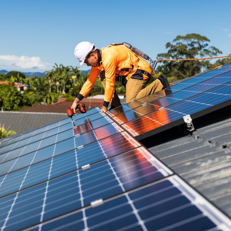 Solar panel technician with drill installing solar panels. Picture by Zstock/Adobe Stock