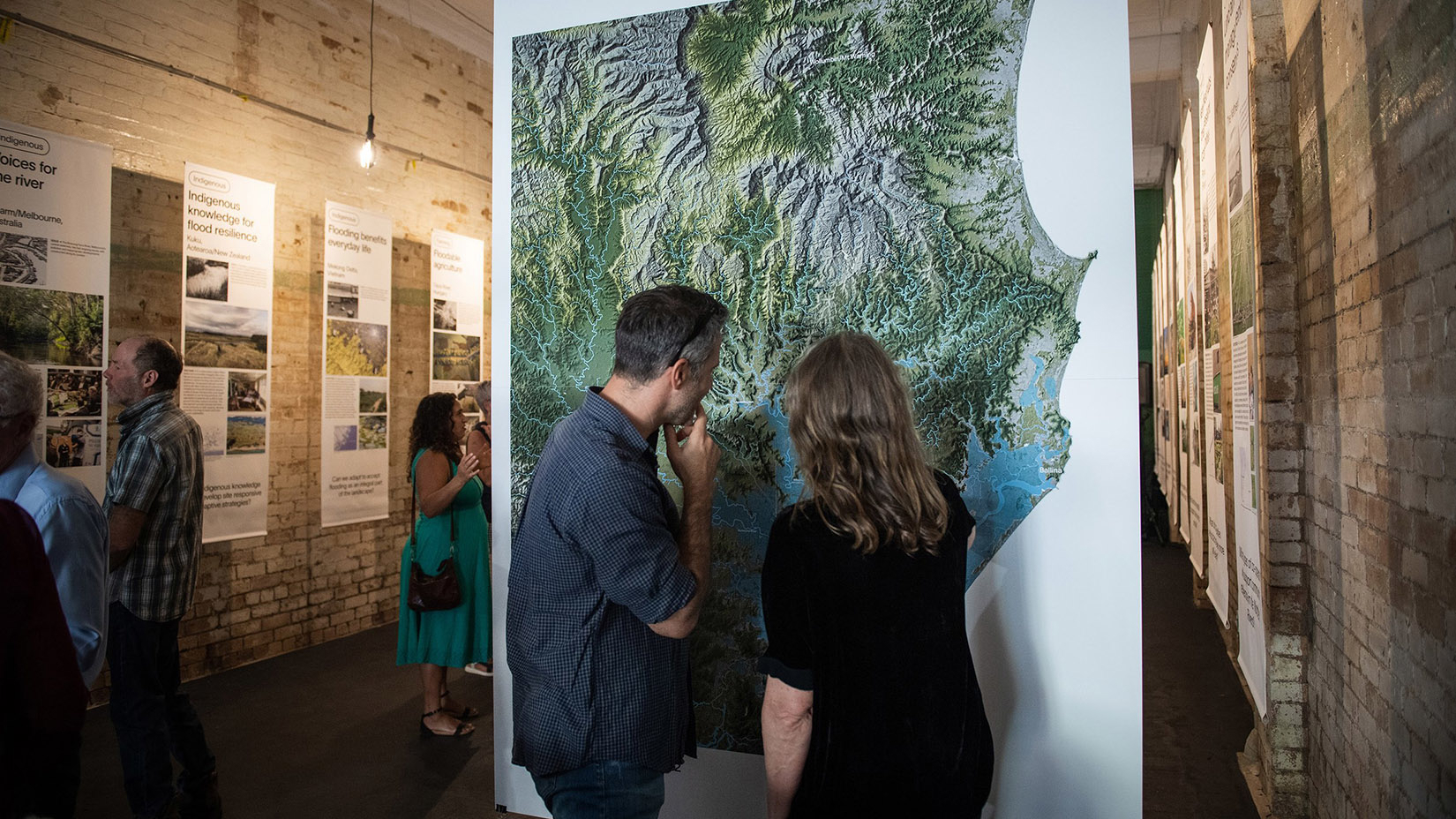 People viewing city plans at an exhibition