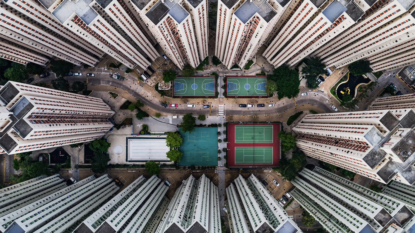 Aerial view of city skyscrapers and tennis courts