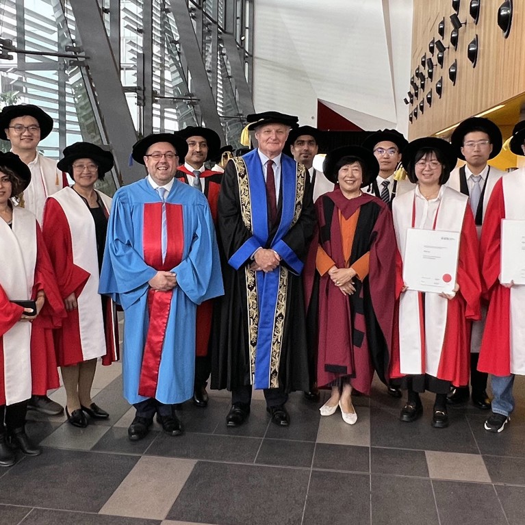 AAII PhD graduates and academics in a group photo following the graduation ceremony.