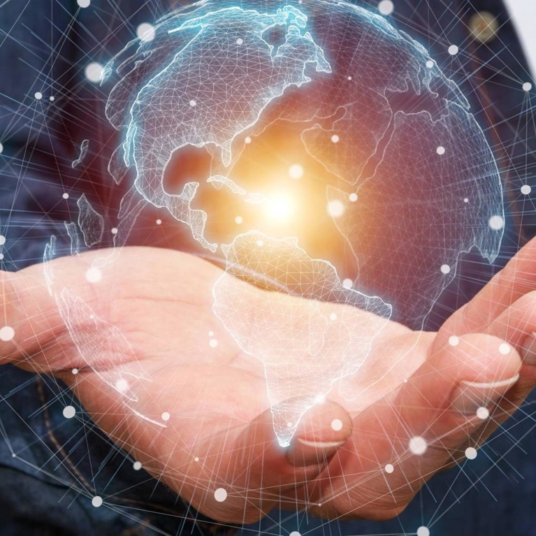 A hand holding the globe