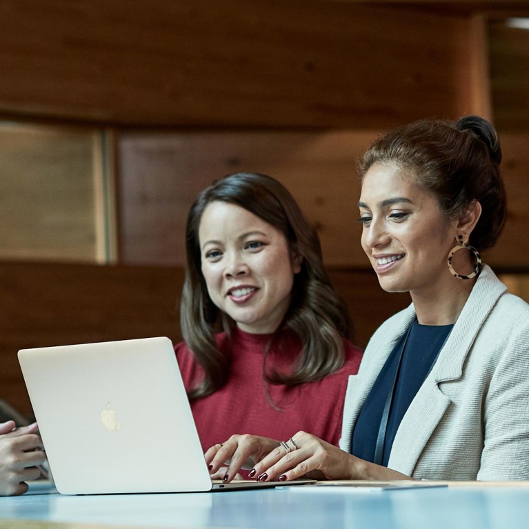 Three women on a laptop studying