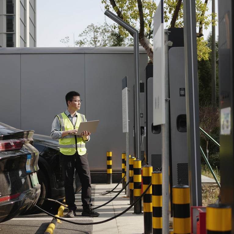 Asian worker uses laptop at electric vehicle charging station
By zhu difeng Adobe Stock