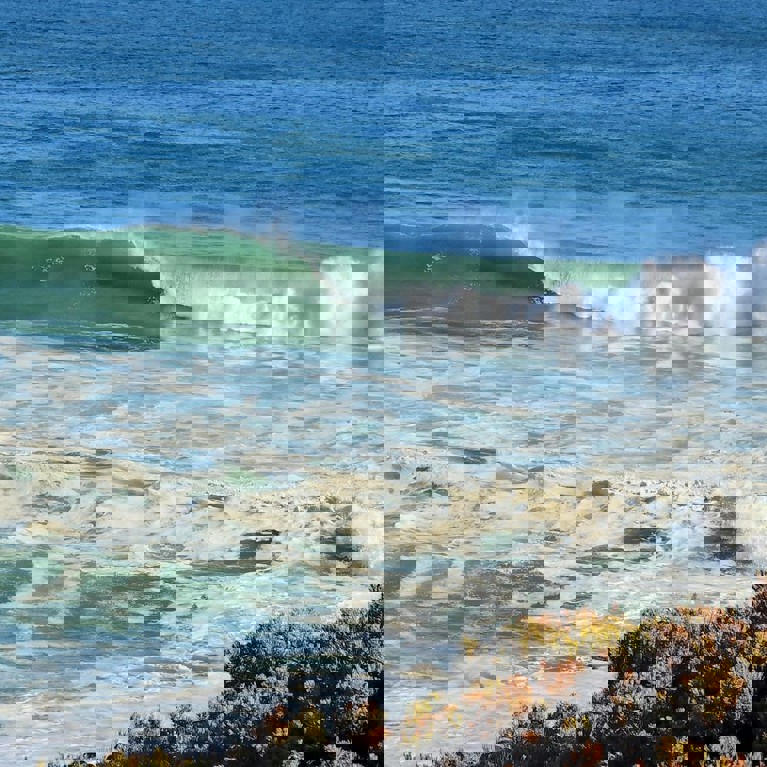 Picture of a surf beach with foam on the wash from breaking waves. Picture by Anthony Rowland