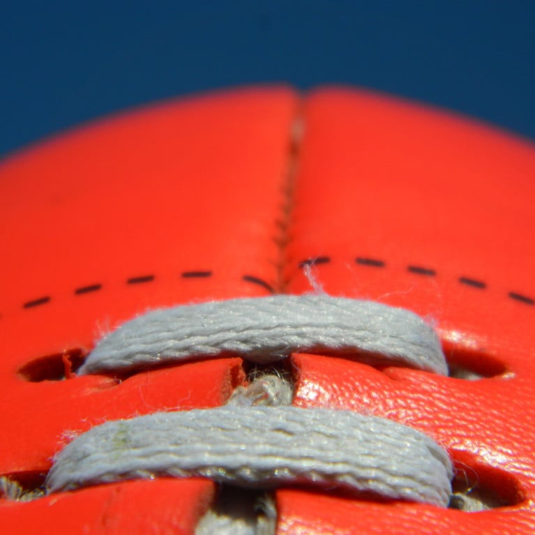 Close up of an Australian rules football on a blue sky background. Picture by Michael/Adobe Stock