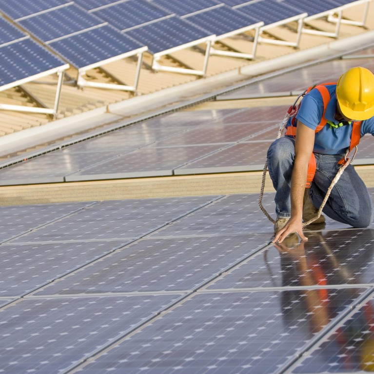 Worker positioning solar panels
