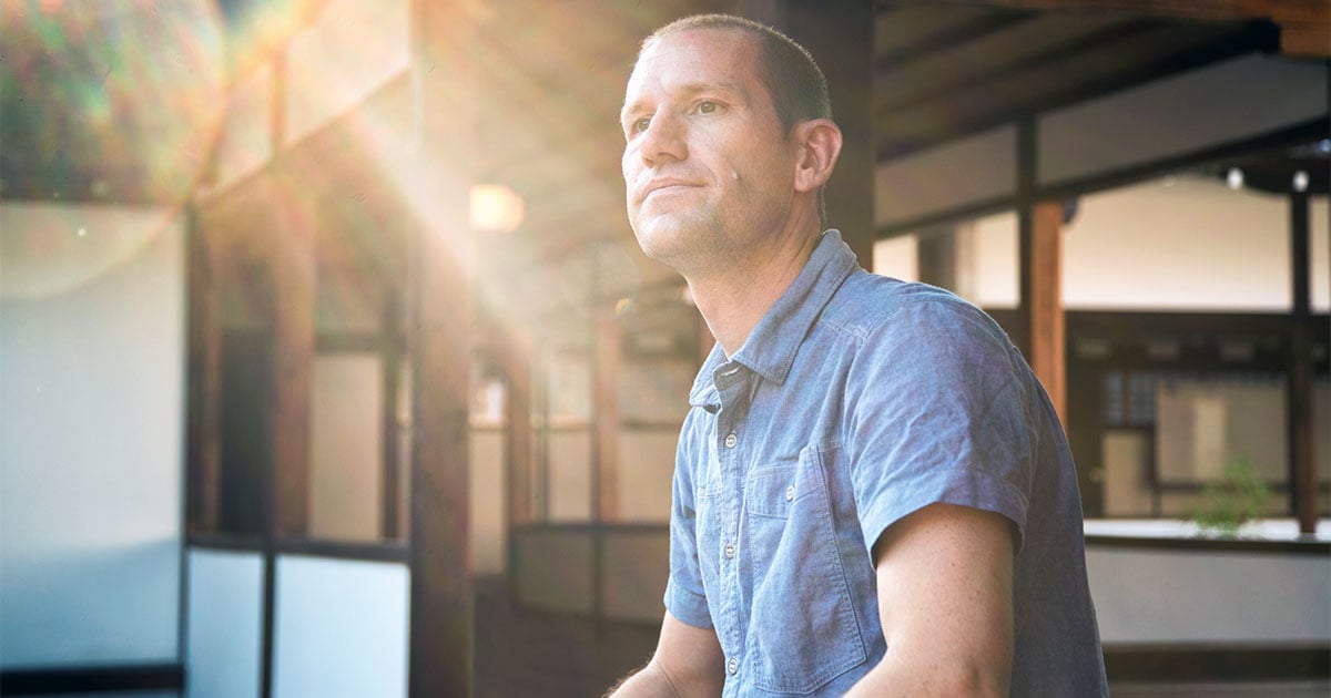 A man in short sleeve shirt seated