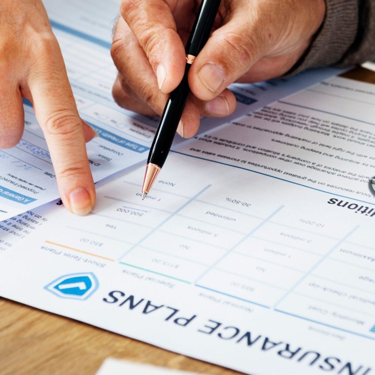 Elderly couple completing health insurance form