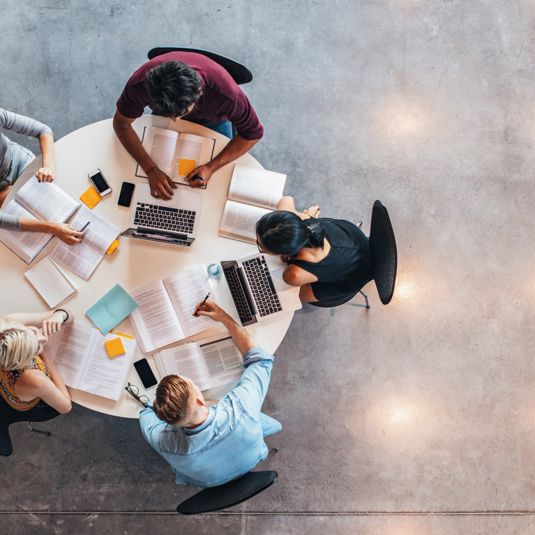 Top view of group of people sitting together at table