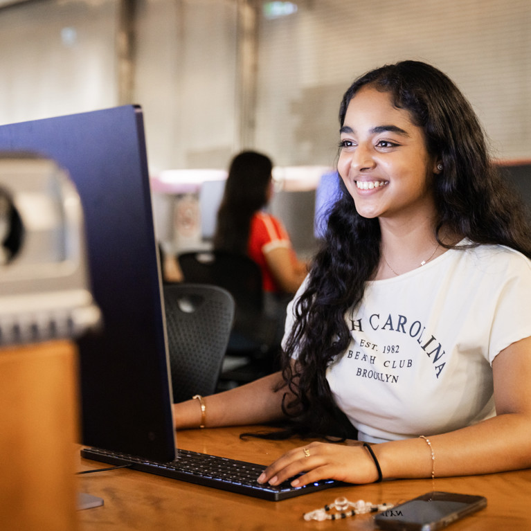 Student on laptop researching resources
