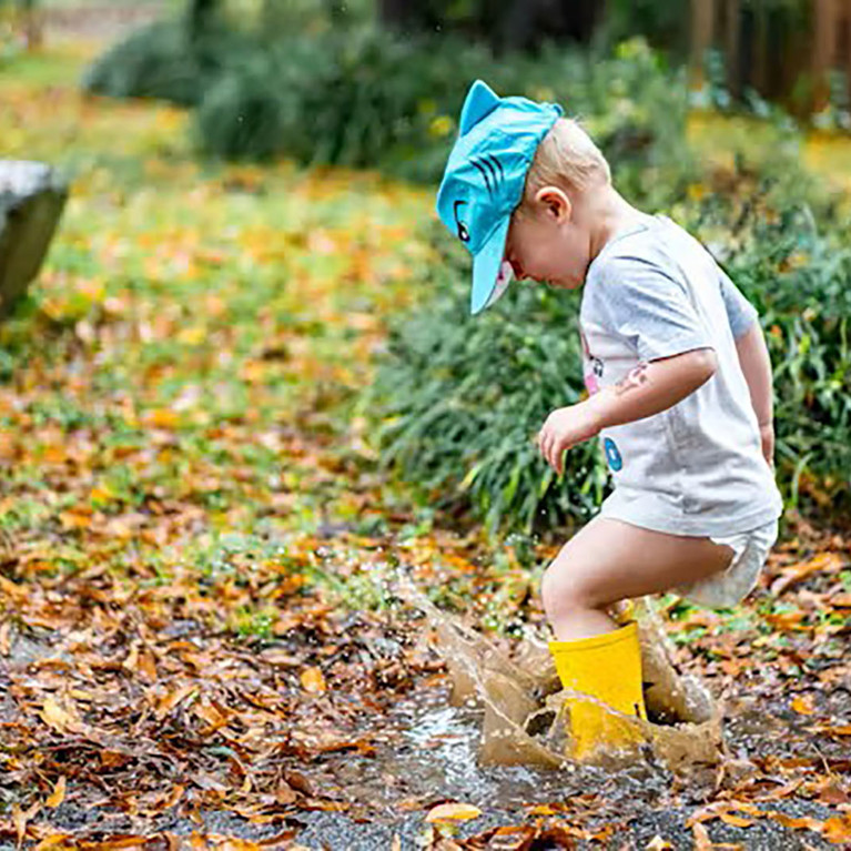 Boy playing in a puddle Zachary Kadolf/Unsplash