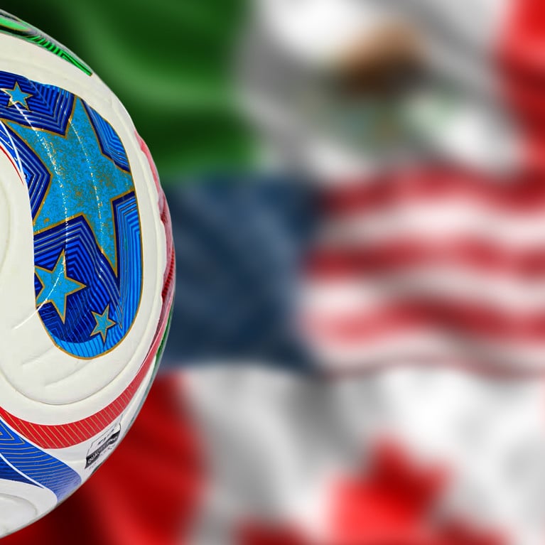 Cropped Adidas Trionda ball for FIFA World Cup 2026 with blurred Mexico United States and Canada flags. Picture: j_chincoya/Adobe Stock