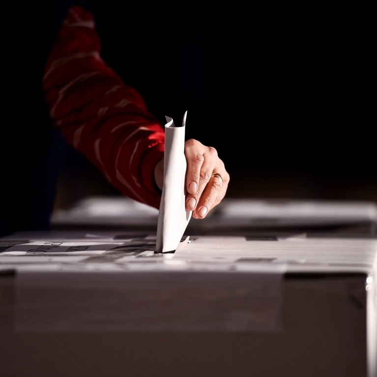 Hand casting a vote into the ballot box. Picture: roibu/Adobe Stock