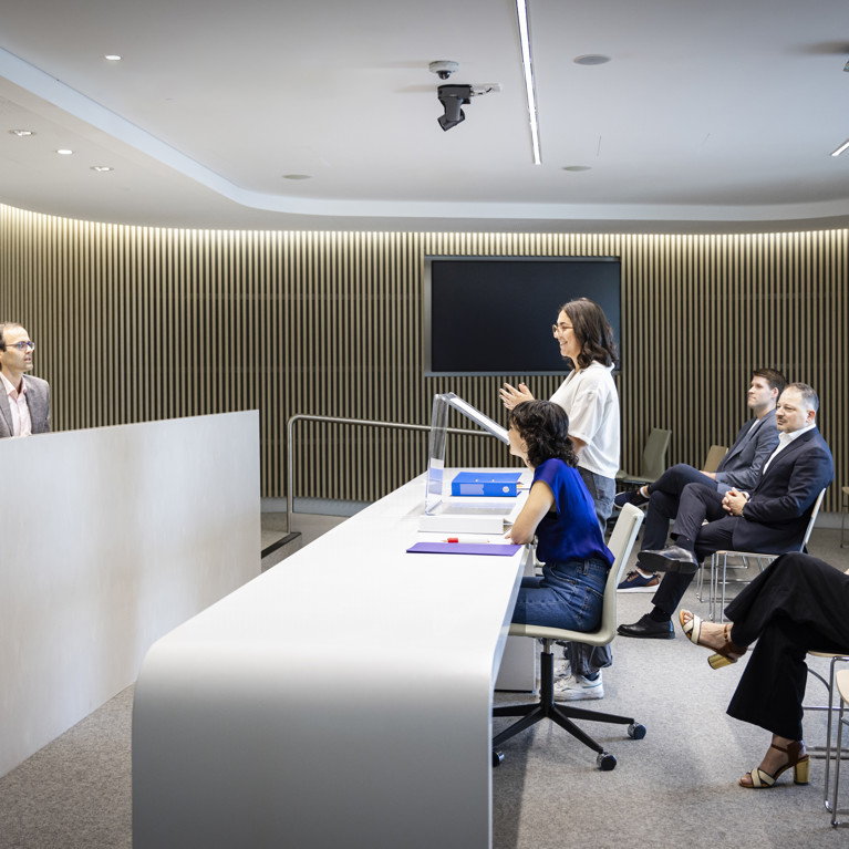 A UTS female student presenting in a moot court for her law practical legal training (plt) at UTS.