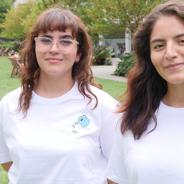 Two UTS students with t-shirts promoting academic integrity outside UTS Alumni Green