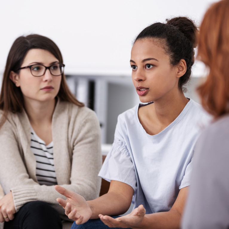 Four women supporting each other during psychotherapy group meeting. Picture: Adobe Stock