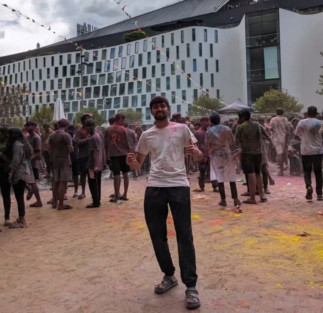 Shiva Sharma at the UTS Holi festival with colourful powder in the air