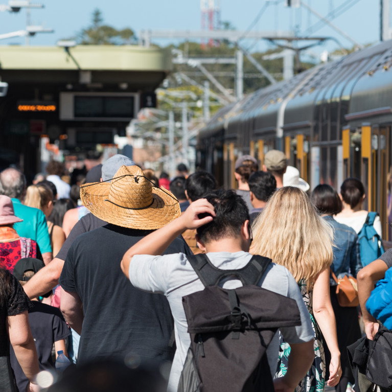 A crowd of people on the platform at Cronulla Station in Sydney, pictured from behind. Picture by Olga Kashubin/Adobe Stock