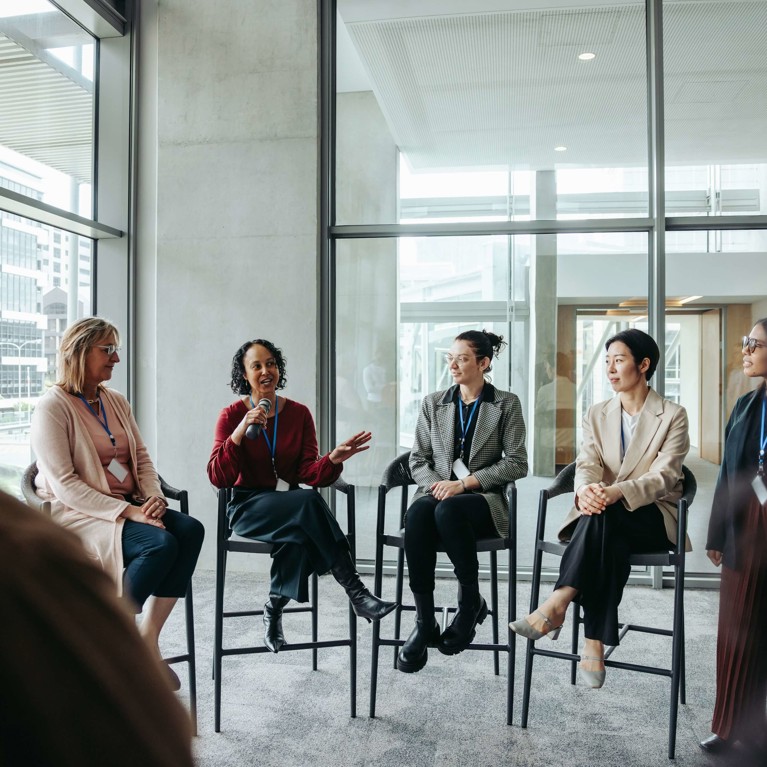 Group of conference participants seated together during a discussion session.
