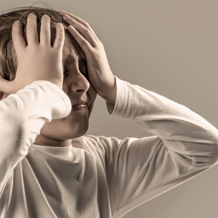 Stock picture of a child in pain holding his head in his hands.
Picture by Yevhen/Adobe Stock