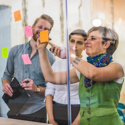 Image of workers putting up post it notes