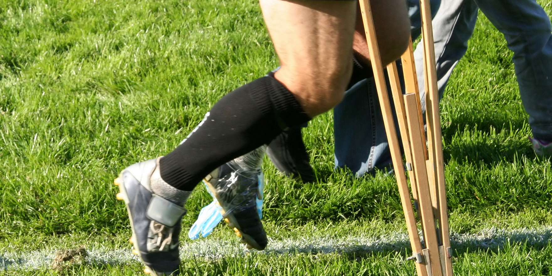 close-up of a footballer using crutches