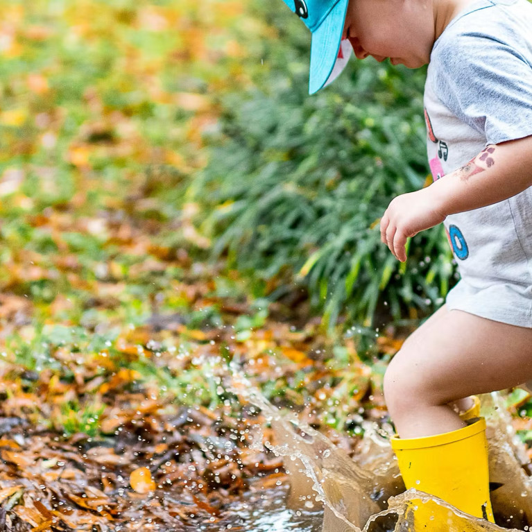 Boy playing in a puddle Zachary Kadolf/Unsplash