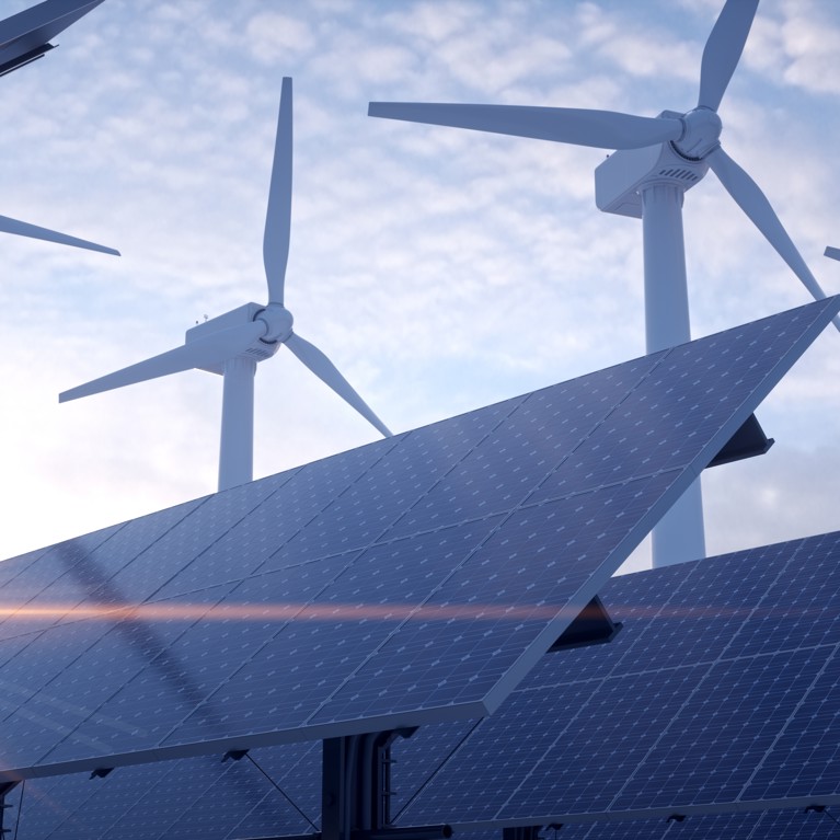 Solar field with wind turbines in the background. Picture by Negro Elkha/Adobe Stock