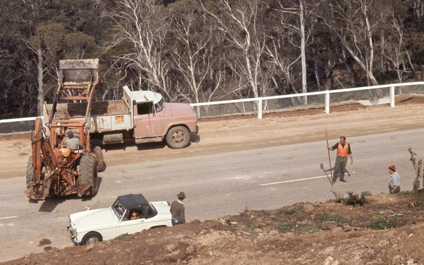 DMR Roadworkers Workers at Snowy Mountains Highway worksite at Brown Mountain, 1969, (cropped). Transport for NSW historical image asset, file no #P03383-13, Box 114, State of New South Wales (Transport for NSW). Creative Commons Attribution 4.0 licence.