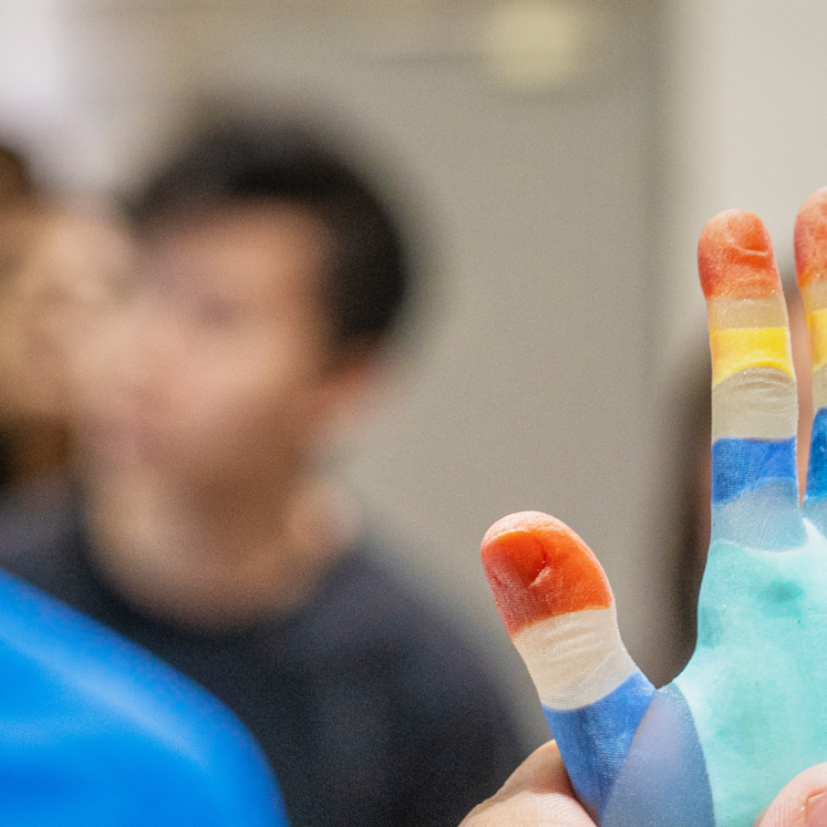 Visitors looking at coloured 3D printed hand sample