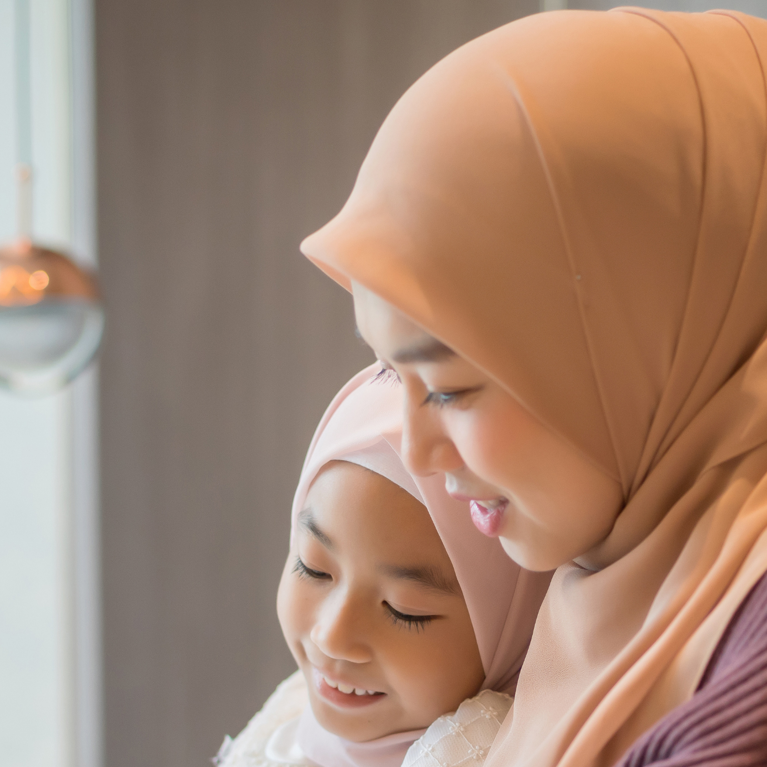 Muslim mother and daughter looking at a tablet