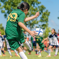 Girl kicking a soccer ball