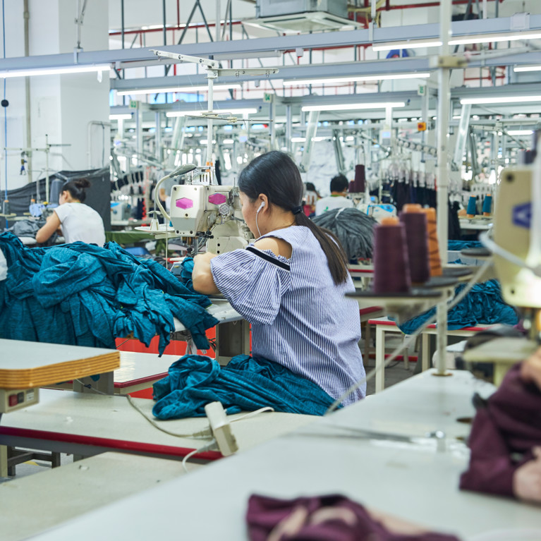 Employees working with their sewing machines in clothing factory. Picture by Lnunes?Adobe Stock